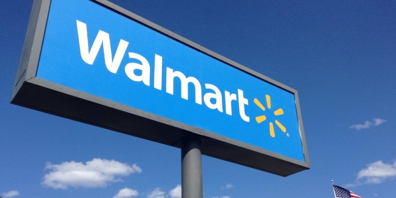 A blue Walmart sign against a clear sky